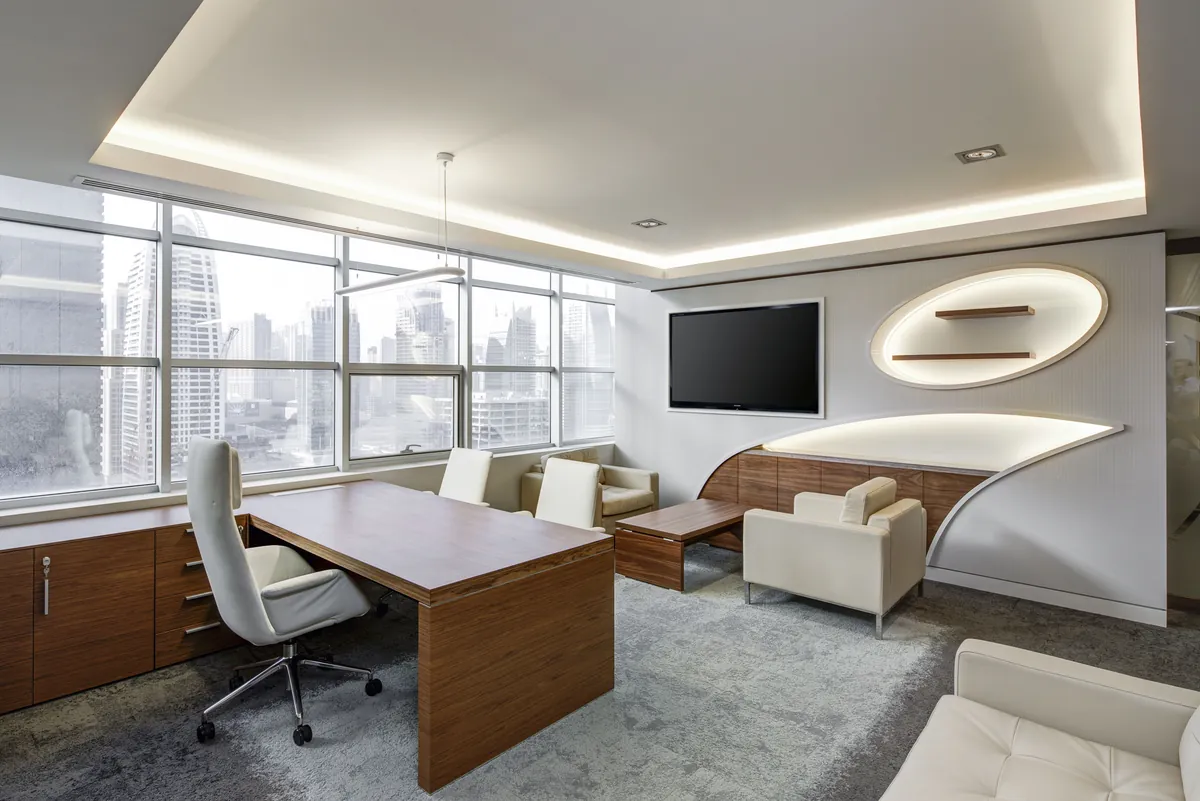 Private executive office with a large desk and a city skyline through the windows