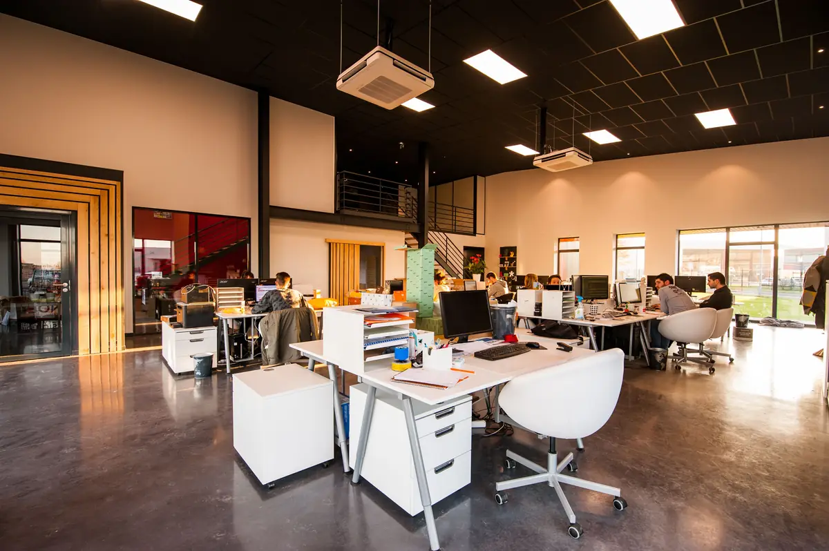 Open office interior with ceiling-mounted air conditioning cassettes