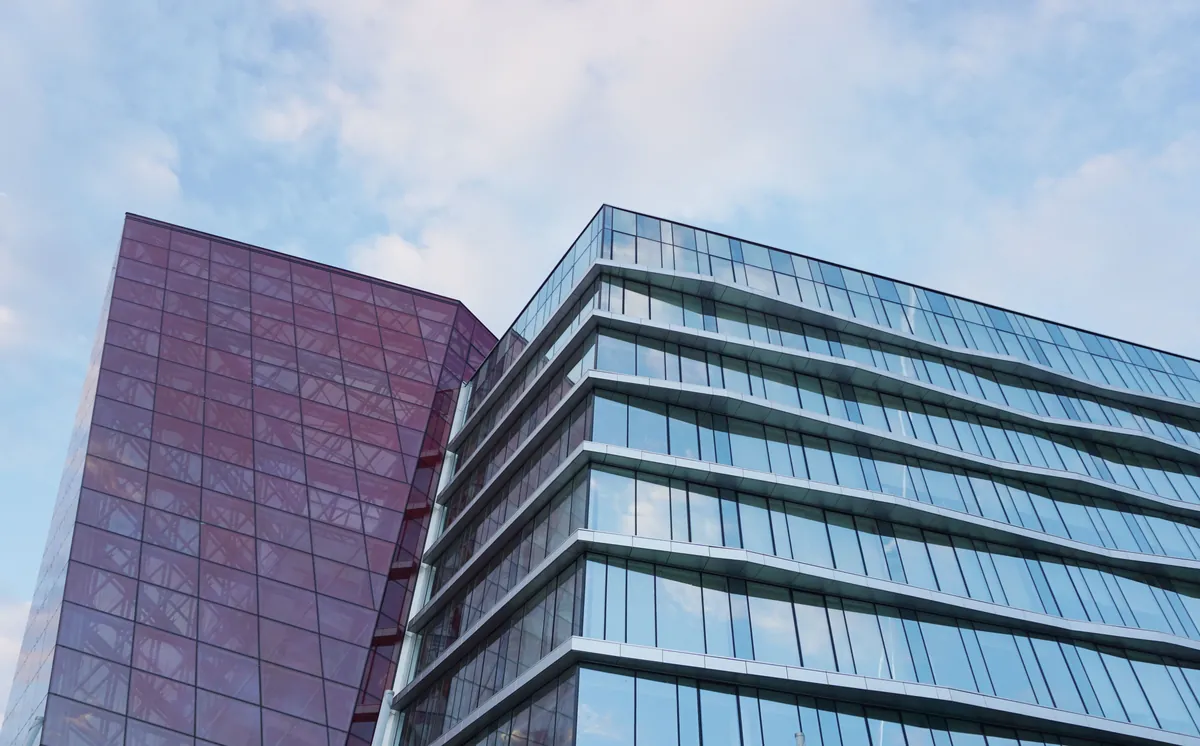 Glass office towers seen from below against the sky